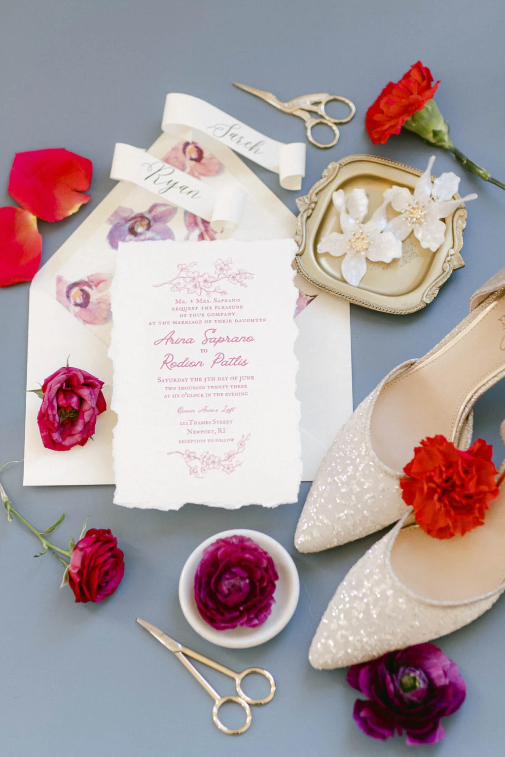 Wedding invitation suite with satin shoes, ribbon and red ranunculus